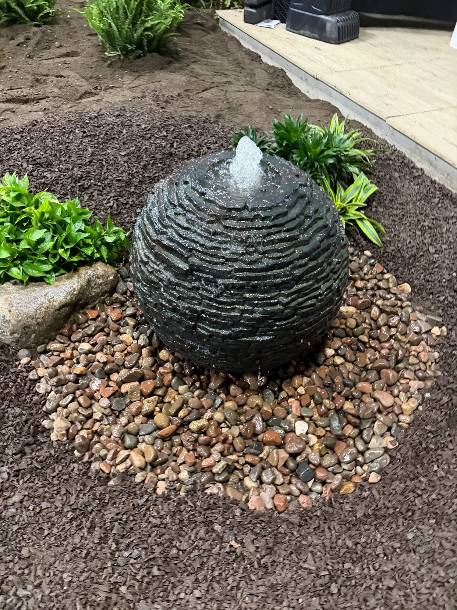 Stone bubbler water feature set in river rock