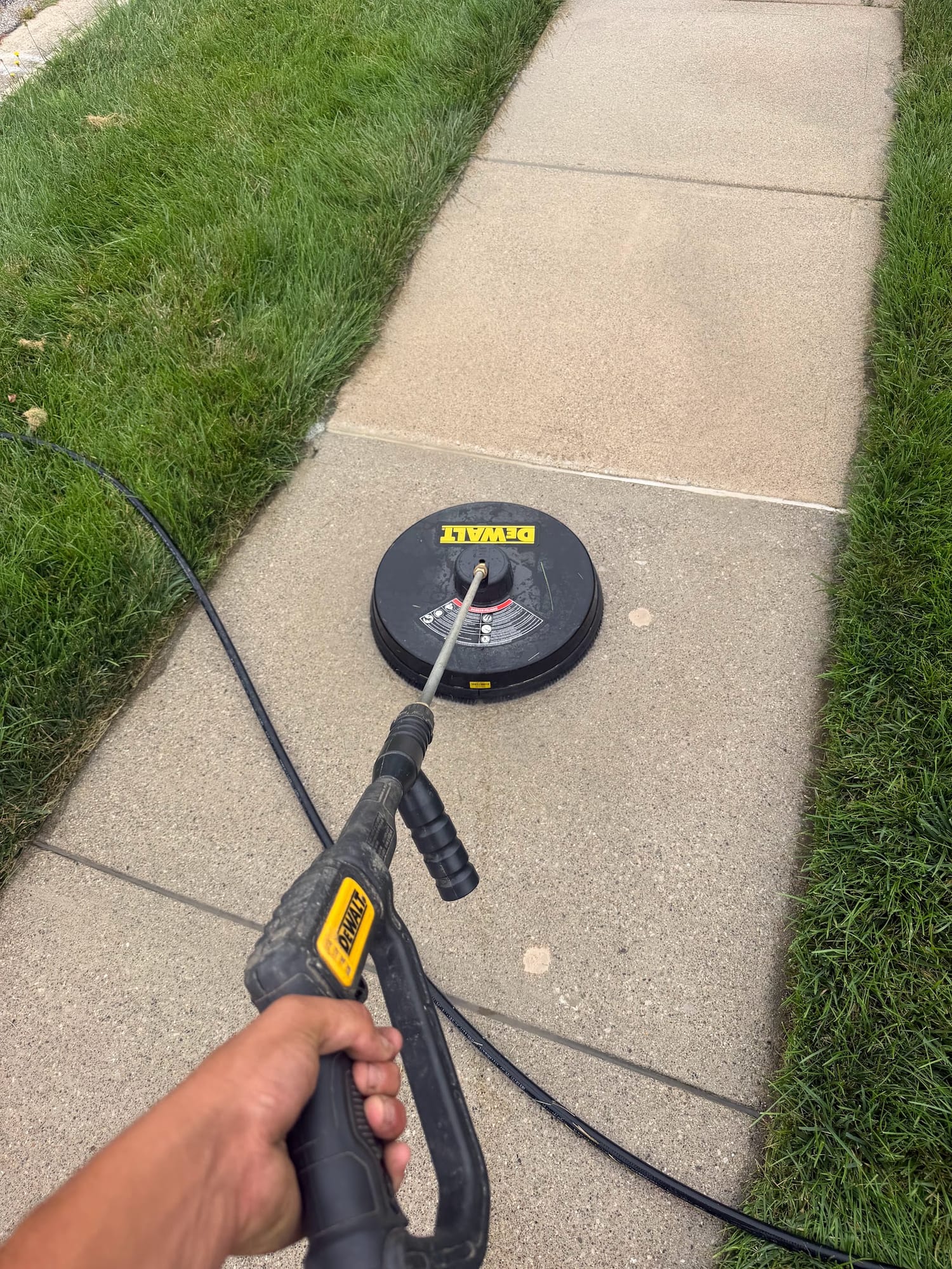 Pressure washing a concrete walkway with a surface cleaner