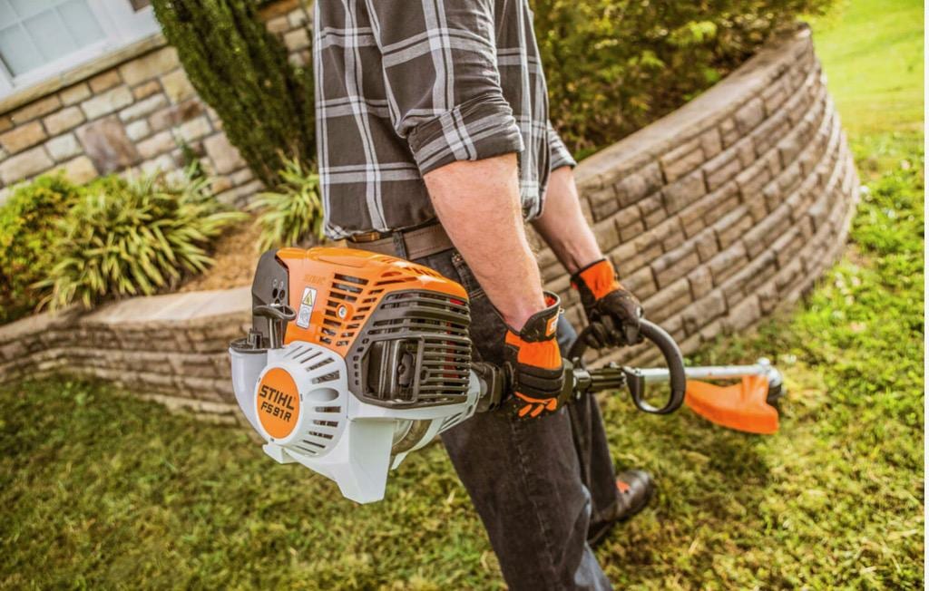 String trimmer detail work along a wall